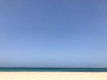 Scenic view of sea against clear blue sky