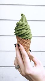 Cropped hand holding ice cream cone