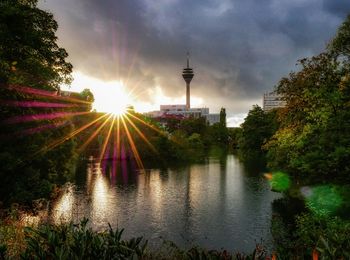 View of canal against cloudy sky during sunset