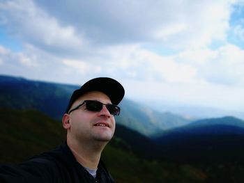 Man wearing sunglasses against sky