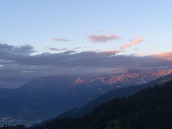 Scenic view of mountains against sky at sunset