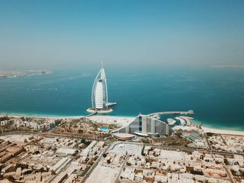 Sailboats in sea against sky