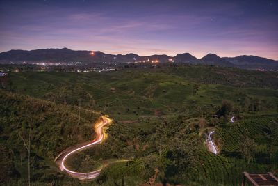 High angle view of illuminated landscape against sky during sunset