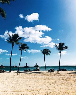 Scenic view of beach against blue sky