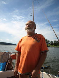 Rear view of man sitting on boat in front of sea
