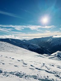 Scenic view of snow covered mountains against sky