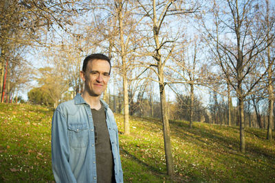 Portrait of young man standing in park