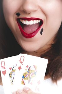 Cropped image of woman with playing cards