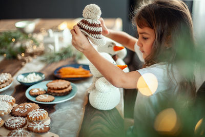 Full length of cute girl having food on table