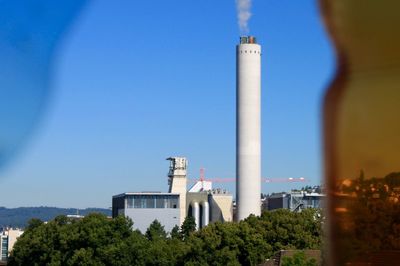 View of factory against clear blue sky