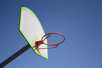 Low angle view of basketball hoop against clear blue sky