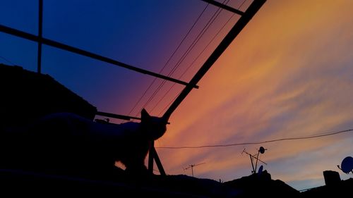 Low angle view of power lines against sky