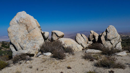 Rock formations in desert against clear blue sky