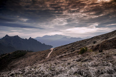 View of mountain range against cloudy sky