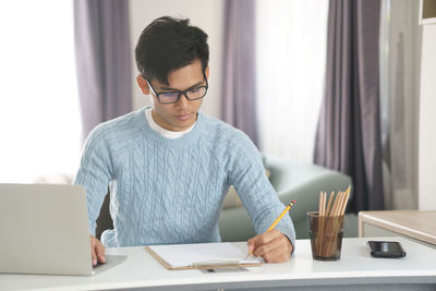 Man using laptop on table