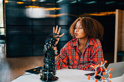 Young woman sitting on table