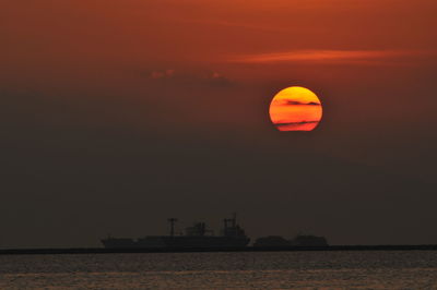 Scenic view of sea against orange sky