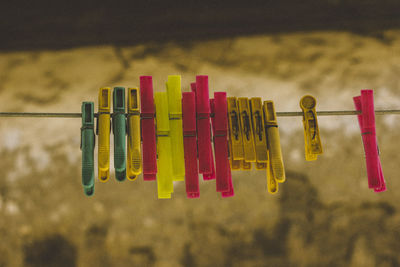 Close-up of clothespins hanging on clothesline