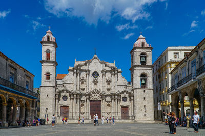 Group of people in front of building against sky