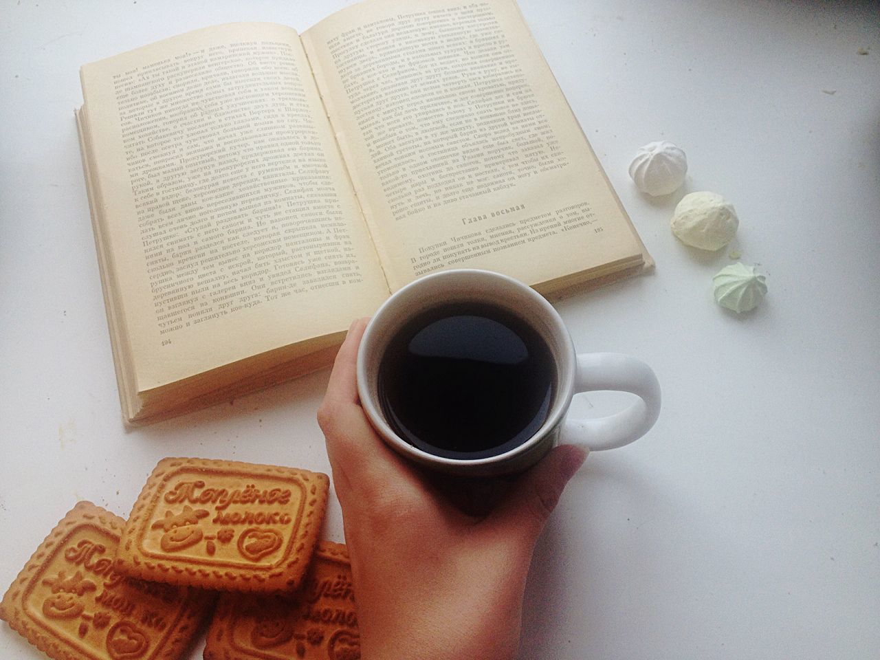 indoors, coffee cup, drink, table, still life, communication, coffee - drink, refreshment, close-up, coffee, text, food and drink, cup, western script, high angle view, technology, book, no people, freshness, saucer