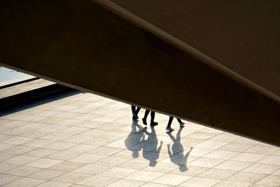 Low section of people standing on tiled floor