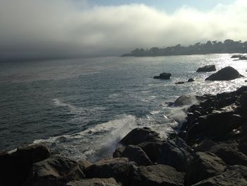 Scenic view of sea against cloudy sky