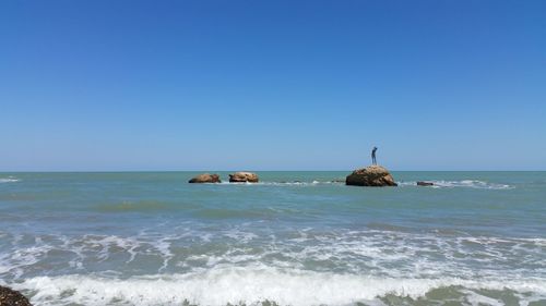 Scenic view of sea against blue sky