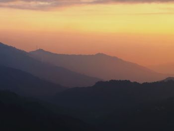 Scenic view of silhouette mountains against sky during sunset