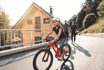 Rear view of man riding bicycle