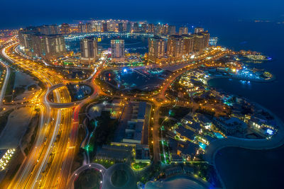 High angle view of illuminated city buildings at night