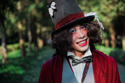 Portrait of a smiling young man cosplaying mad hatter