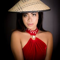 Portrait of young woman wearing asian style conical hat