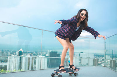 Full length of woman on railing against clear sky