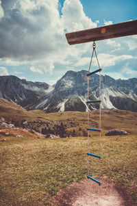 Wind turbines hanging on mountain against sky