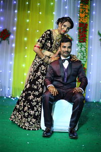 Portrait of smiling bride standing by groom during wedding ceremony