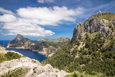 Scenic view of sea and mountains against sky