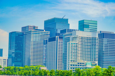 Modern buildings in city against sky