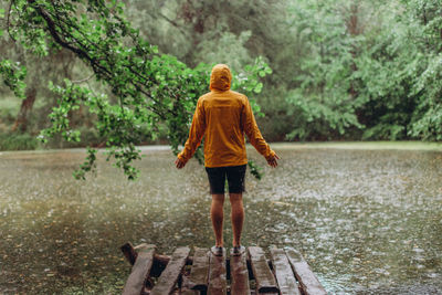 Rear view of a man walking in rain
