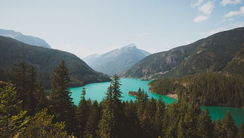 Scenic view of lake by mountains against sky