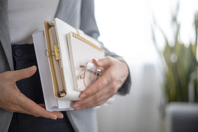 Midsection of woman holding book