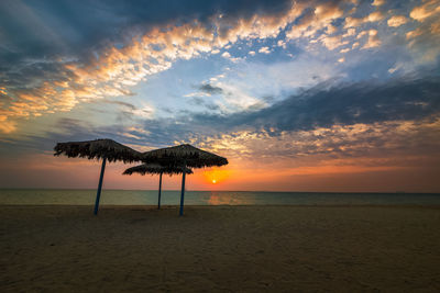 Scenic view of beach against sky during sunset