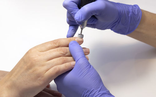 Cropped hands of doctor holding nail polish
