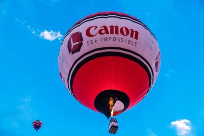 Low angle view of hot air balloon against blue sky