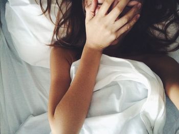 Directly above view of woman lying on bed