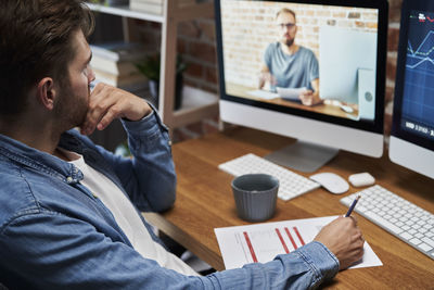 Side view of man working in office