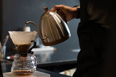 Man pouring coffee in cup