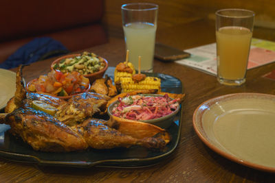 Close-up of fresh meal served with drinks on table at restaurant