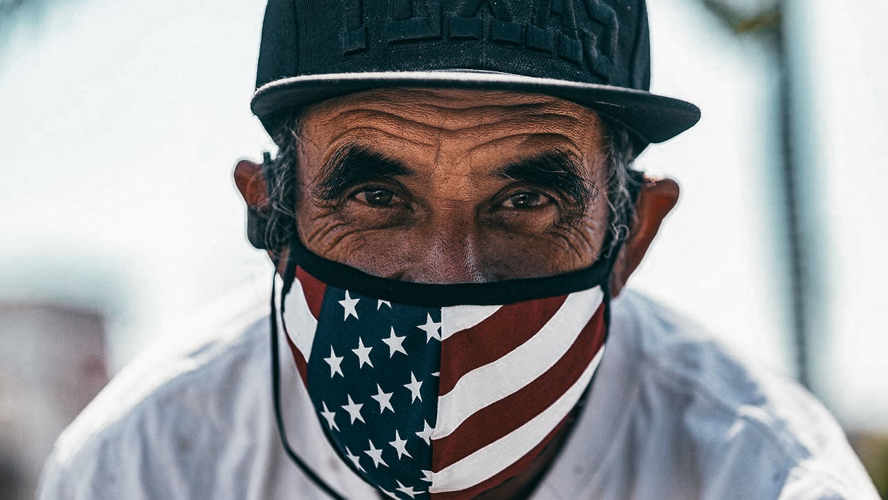 CLOSE-UP PORTRAIT OF MAN WITH FLAG IN MOUTH