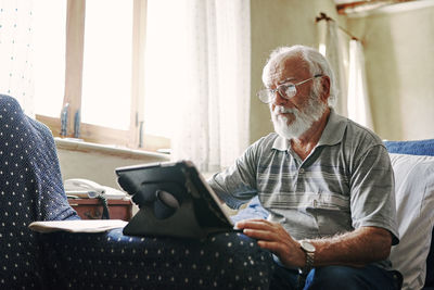 Midsection of man sitting at home