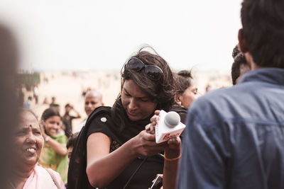 Journalist holding microphone in city